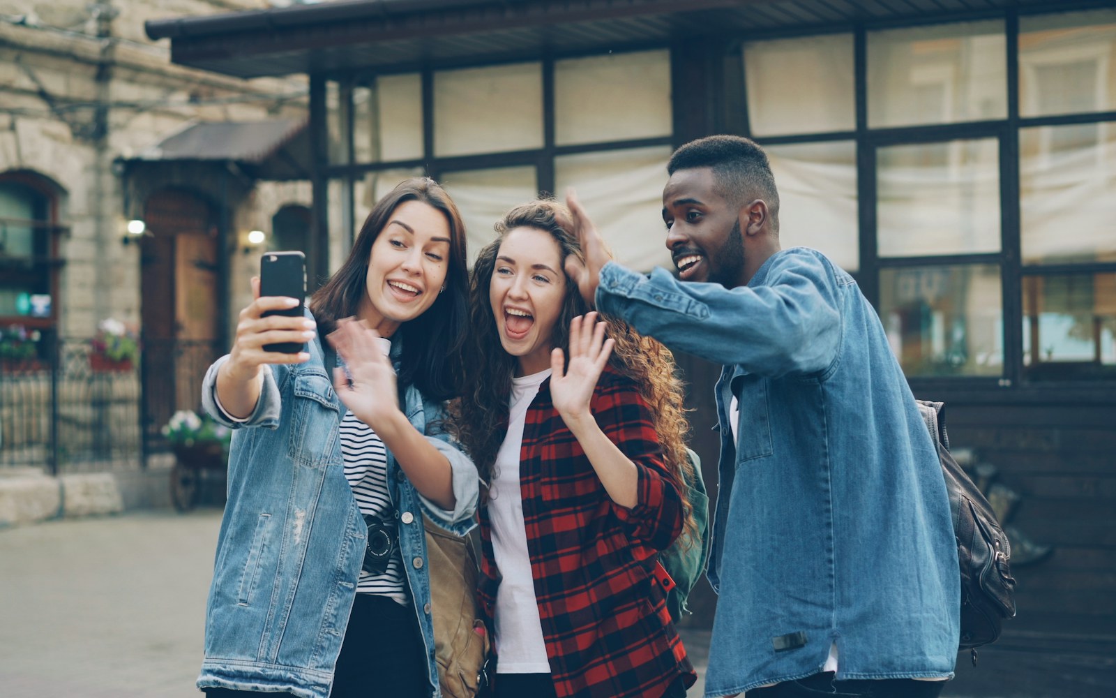 Friends recording a shareable everyday moment on a smartphone